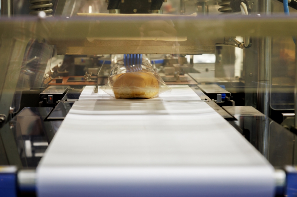Bread products going through an automated packaging process.