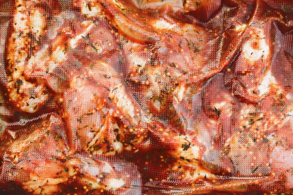 High liquid content marinated meat vacuum packaged.